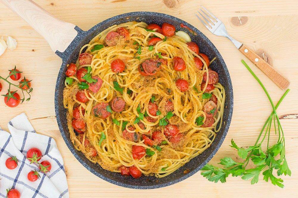 VERMICELLI MMOLLICATI - Delicious dish of vermicelli pasta with tomatoes and herbs in a skillet.