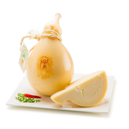 Caciocavallo Silano DOP cheese, semi-aged, buttery flavor, pear-shaped, with smooth rind and mold, served on a plate.