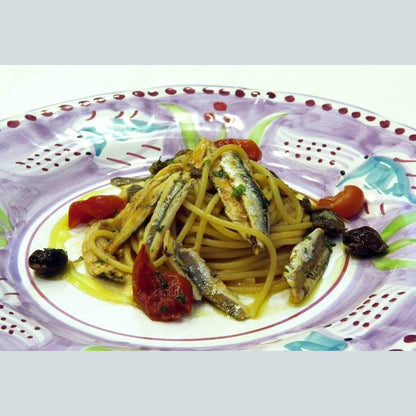 Pasta with anchovies and cherry tomatoes, a dish enhanced by Colatura di Alici for Mediterranean flavor.